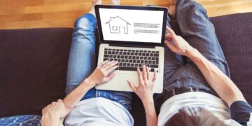 young family couple choosing new home online, search real estate to buy or rent, house for sale on screen of computer