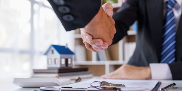 Handshake Real estate brokerage agent Deliver a sample of a model house to the customer, mortgage loan agreement Making lease and buy and sell house And contract home insurance mortgage loan concept